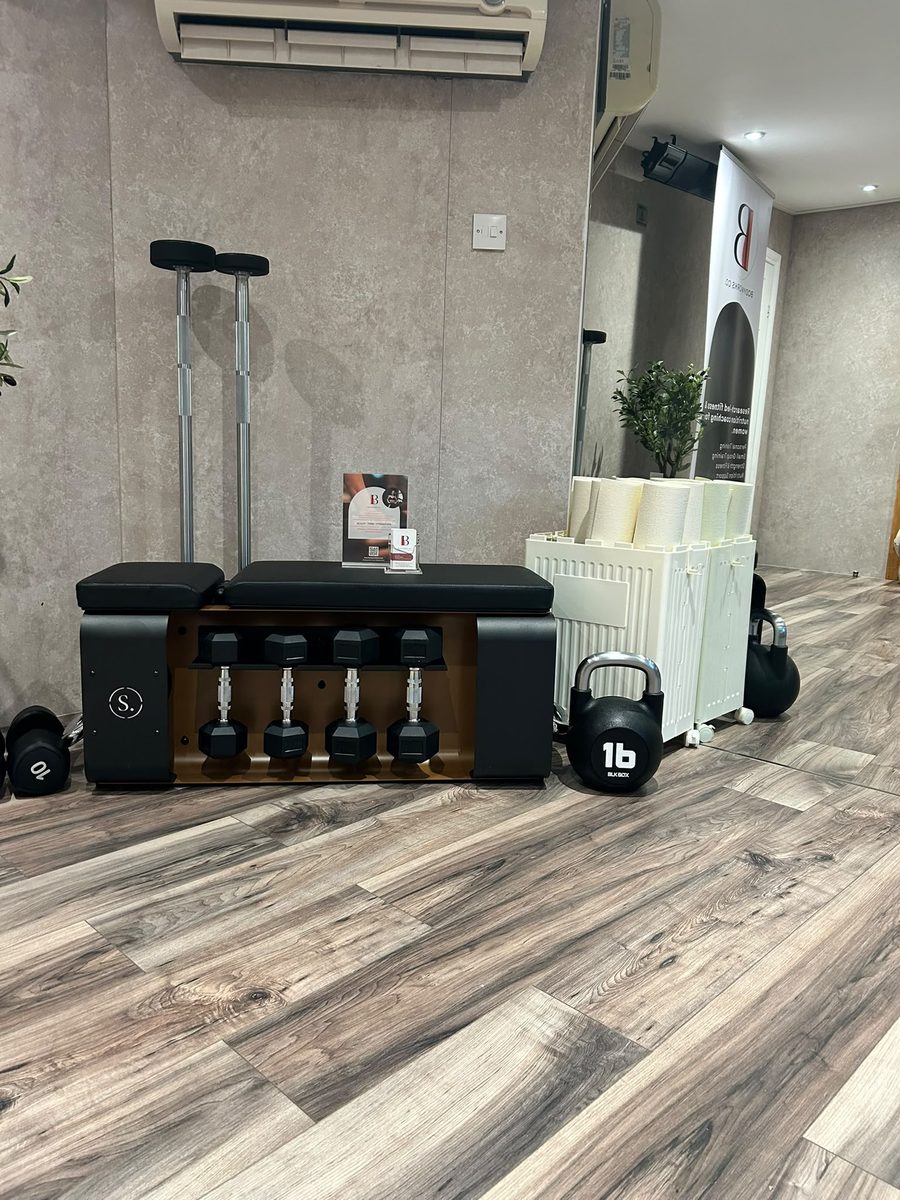 Bench, dumbbells and kettlebells set up in the Bodyworks Co. studio at Studio 220